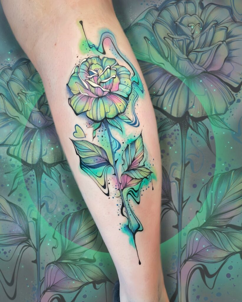 Colorful floral tattoo on a calf featuring a stylized flower with swirling iridescent colors.
