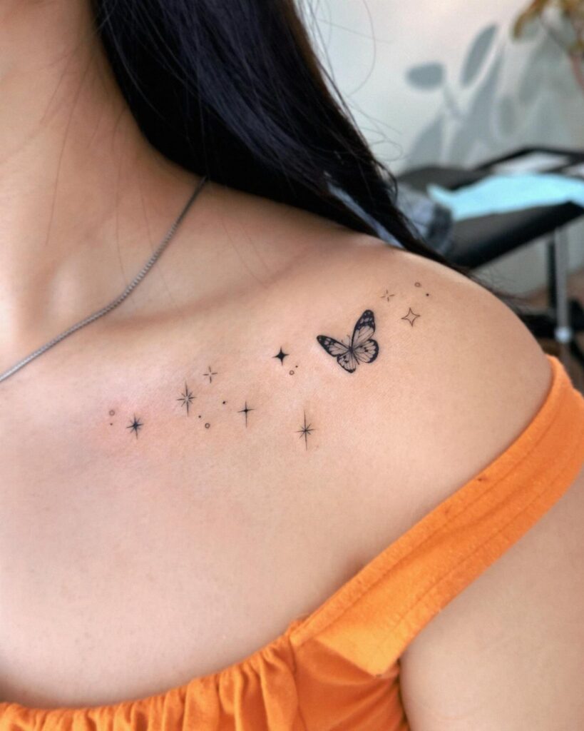 Butterfly and star tattoos on a woman's collarbone and shoulder area