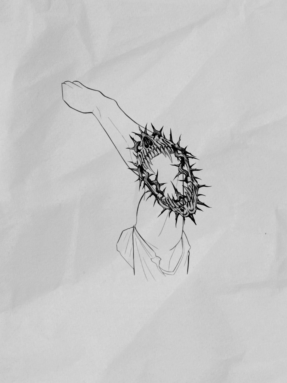 Spiked circular tattoo design on a person's elbow drawn in black ink on paper.